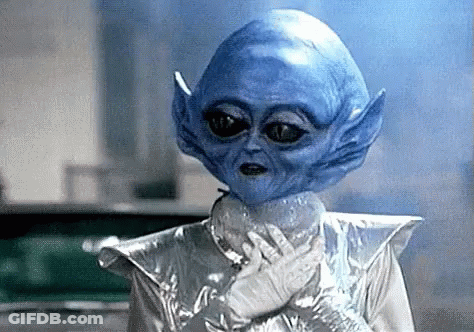 Blue Alien In Silver Costume GIF