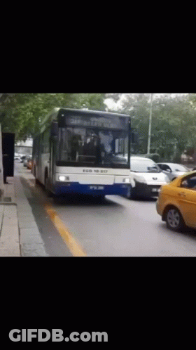 Blue And White Bus Driving Down Road GIF