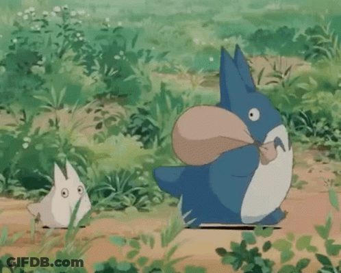 Blue And White Totoro Holding Bag In Mouth With Smaller Totoro GIF