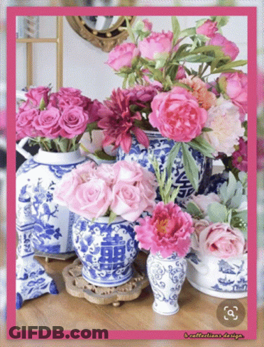 Blue And White Vases Filled With Pink Flowers With A Pink Frame GIF