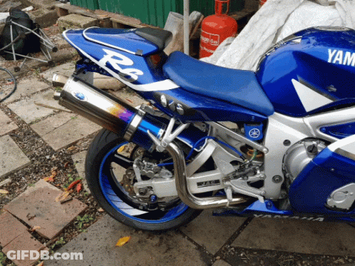 Blue And White Yamaha Motorcycle Parked Outside GIF