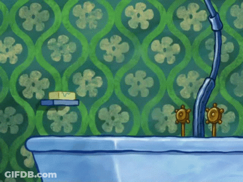 Blue Bathtub In Front Of Wall With Green Flowers GIF