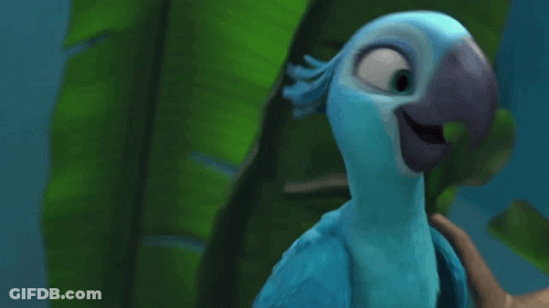 Blue Bird With Long Neck Standing In Front Of Green Leaves GIF