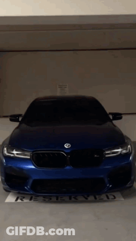 Blue BMW Parked In Reserved Parking Lot GIF