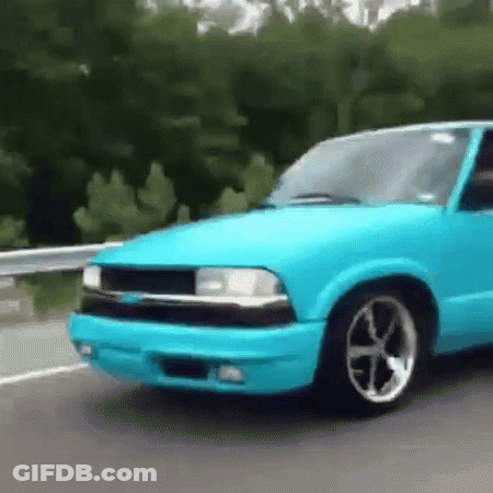 Blue Car Driving Down Highway Next To Trees GIF