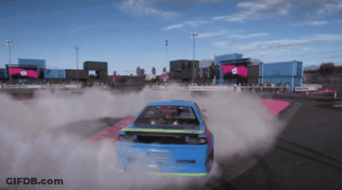 Blue Car Driving On Track With Smoke GIF
