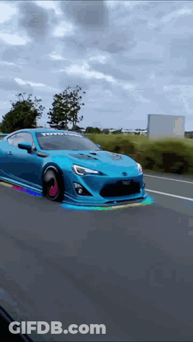 Blue Car With Toyota Logo Driving Down Road GIF