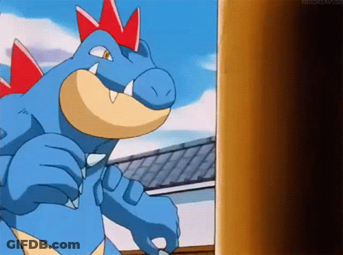 Blue Dinosaur With Red Spikes Next To Building GIF
