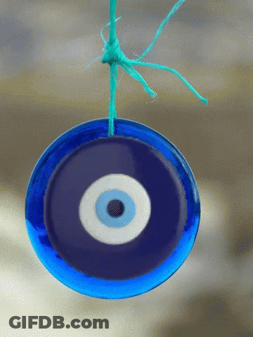 Blue Evil Eye Hanging From String GIF