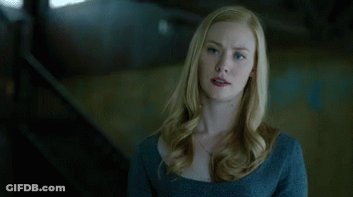 Blue-Eyed Blonde Woman In Blue Sweater And Necklace GIF