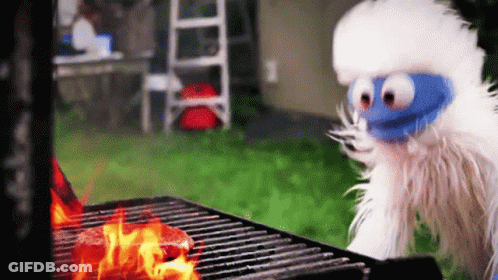 Blue-Faced Stuffed Animal By Grill With Steak GIF