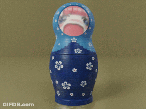 Blue Green And Orange Nesting Doll With White Flowers GIF