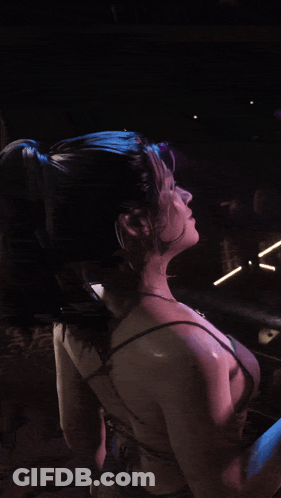 Blue Hair Woman Holding Drink In Front Of Sign Saying N GIF