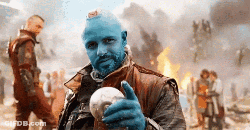 Blue-Haired Bearded Man Holding Light Bulb Thumbs Up GIF