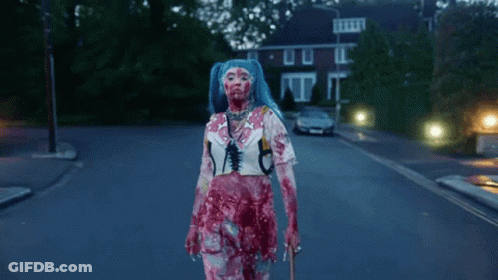 Blue-Haired Woman Covered In Blood Walking Down Street GIF