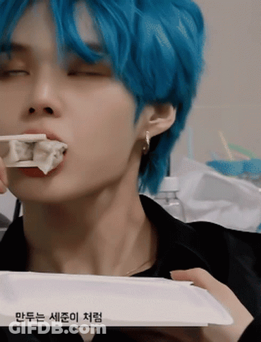 Blue-Haired Young Man Eating Dumplings With Chopsticks GIF
