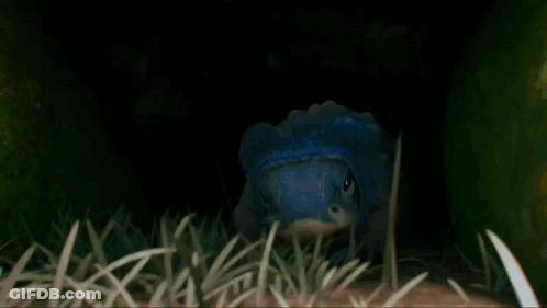 Blue Head Cartoon Crawling In Grass GIF