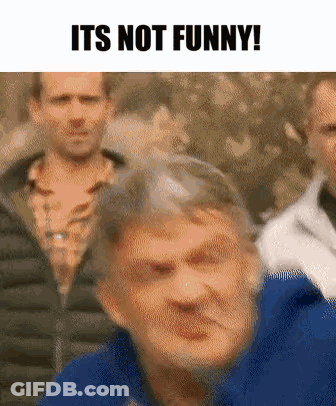 Blue Jacket Man Making Funny Face At Group GIF