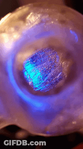 Blue Light Shining On Sphere With Purple Background GIF