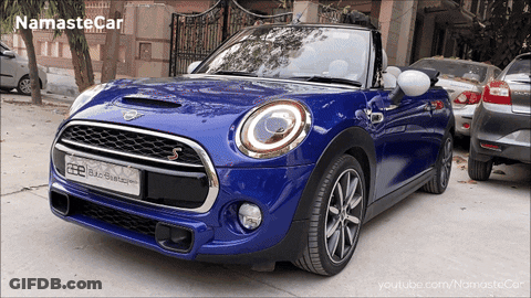 Blue Mini Cooper Parked In Front Of Fence With Words Namaste Car GIF