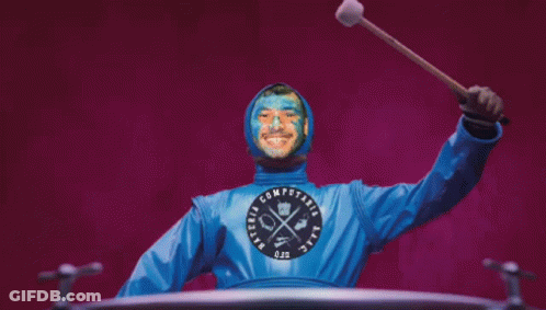 Blue Painted Man Holding Stick In Computaria Shirt GIF