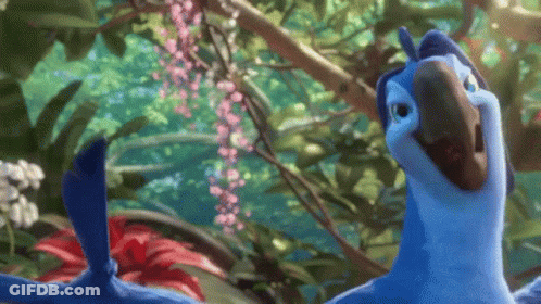 Blue Parrot Standing In Jungle With Pink Flowers GIF