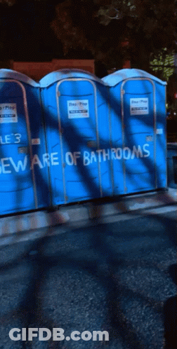 Blue Portable Toilets With Beware Of Bathrooms Written On Them GIF
