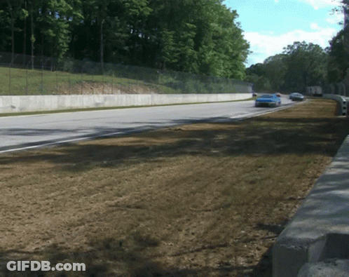 Blue Race Car Driving Down Road GIF