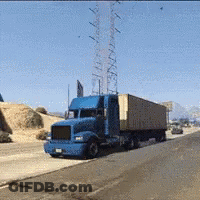 Blue Semi Truck Driving Past Tower GIF