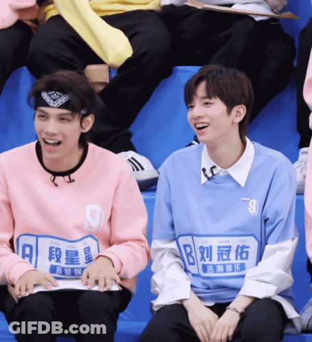 Blue Shirt Boy Number 9 Next To Pink Shirt Boy GIF