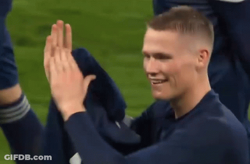 Blue Shirt Man High Fiving Another Man GIF