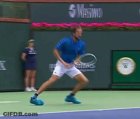Blue Shirt Man Holding Tennis Racquet Masimo Sign GIF