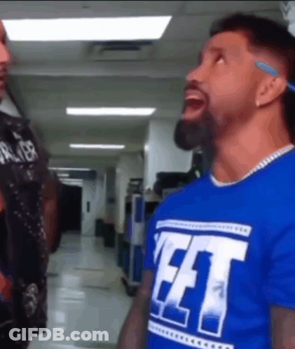 Blue Shirt Man Saying FFT To Another In Hallway GIF