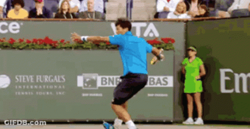 Blue Shirt Man Swinging Tennis Racquet At Steve Furgals Banner GIF
