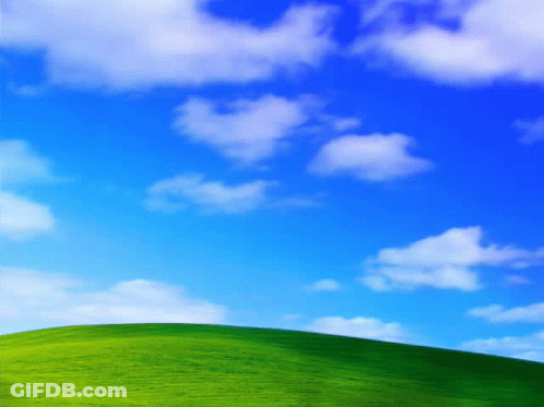 Blue Sky With White Clouds Over Green Hill GIF