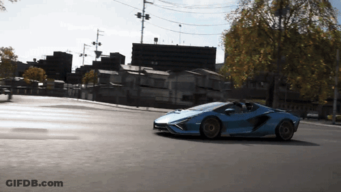Blue Sports Car Driving Down City Street GIF