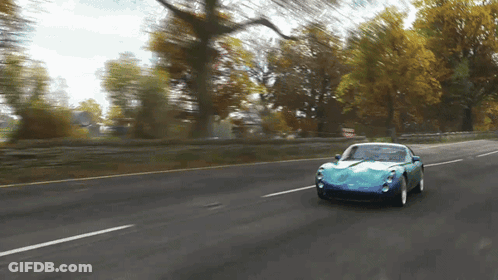 Blue Sports Car Driving Down Road GIF