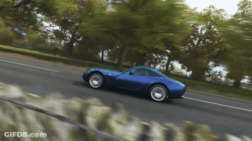 Blue Sports Car Driving Down Road GIF