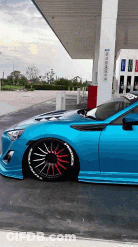 Blue Sports Car Parked At Gas Station GIF