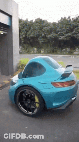 Blue Sports Car With Yellow Tire Parked GIF