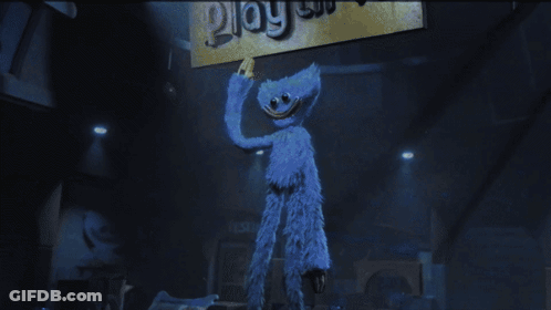 Blue Stuffed Animal Holding Play Sign GIF