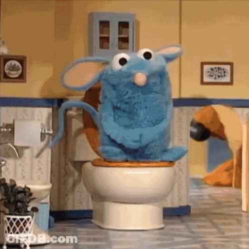 Blue Stuffed Animal Sitting On Toilet GIF