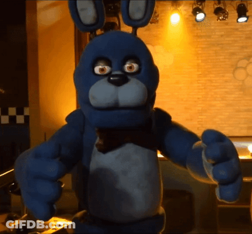 Blue Stuffed Animal With Bow Tie In Dark Room GIF