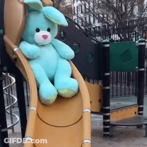 Blue Stuffed Bunny Sitting On Slide GIF