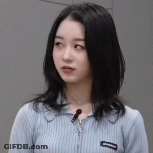 Blue Sweater Woman With Zipper And Necklace Looking At Camera GIF