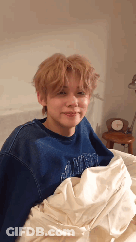 Blue Sweatshirt Young Man Laying On White Blanket GIF