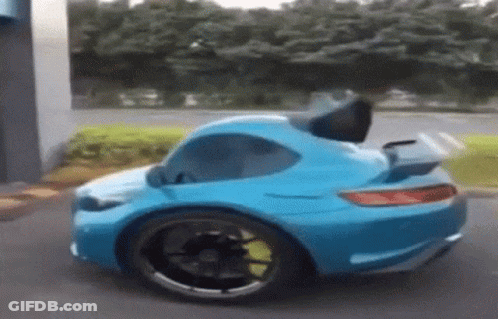 Blue Toy Car With Trunk Open In Parking Lot GIF