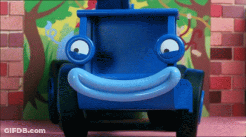 Blue Toy Truck With Smiley Face By Brick Wall GIF