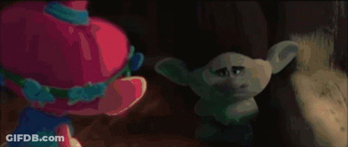 Blue Troll With Purple Hat Holding Red Object GIF