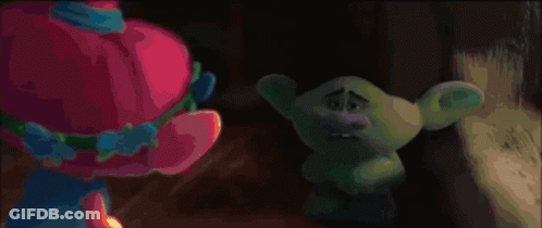 Blue Troll With Purple Hat Standing In Grass GIF